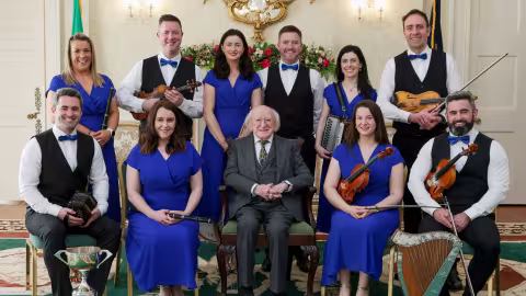 Image showing the Beartla O Flatharta Céili Band members with President Higgins